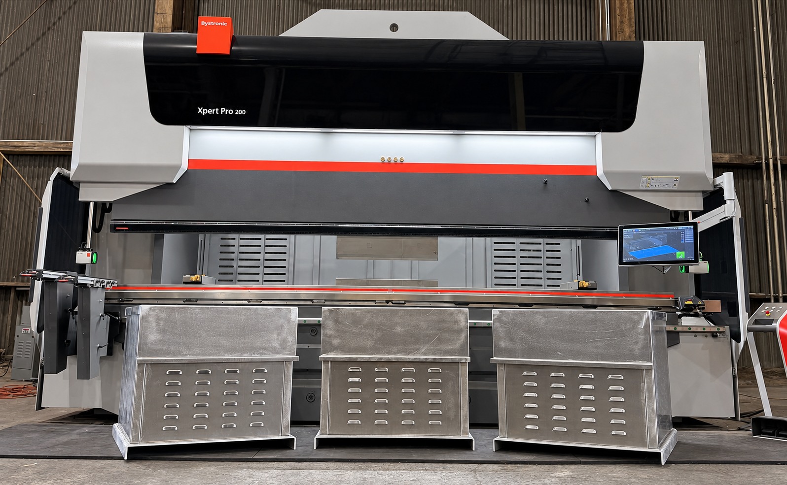 Three fabricated metal enclosures in front of the Forma Systems press brake